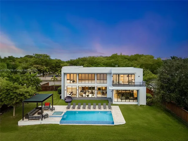 swimming pool view with a seating space and a view of a house with a big yard