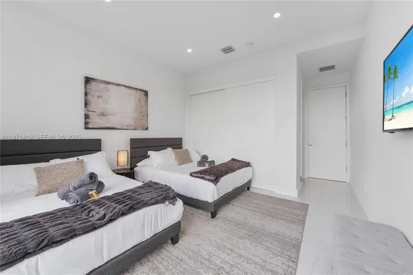 a living room with couches and painting on the wall