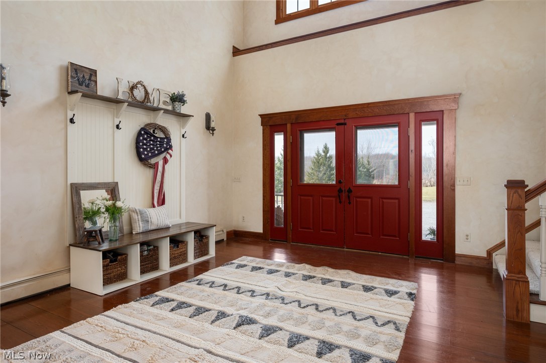 9419 Robinson Road Chardon, OH 44024 - Photo 15 of 46 Foyer featuring dark wood-style floors, a baseboard heating unit, and a high ceiling