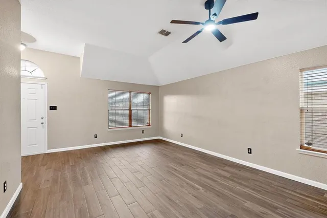 wooden floor in an empty room with a window