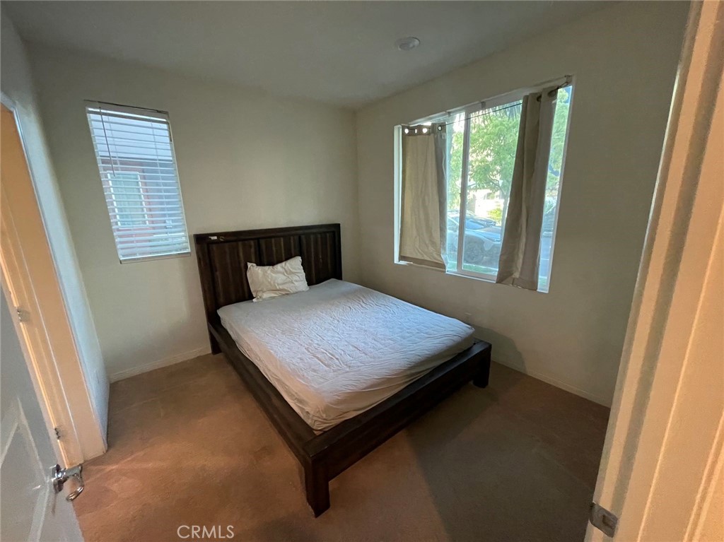 136 Unity Irvine, CA 92614 - Photo 3 of 15 a bed sitting in a bedroom next to a window