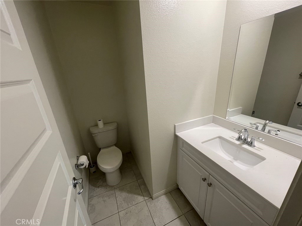 136 Unity Irvine, CA 92614 - Photo 4 of 15 a bathroom with a granite countertop sink and a mirror