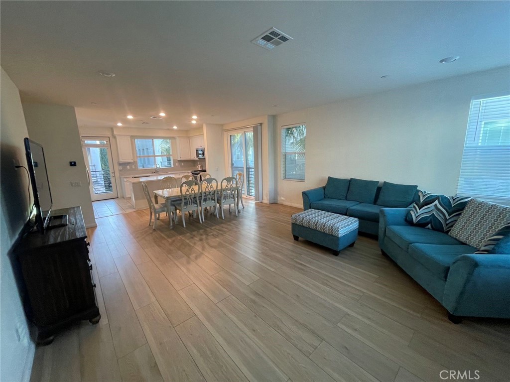 136 Unity Irvine, CA 92614 - Photo 7 of 15 a living room with furniture and a wooden floor
