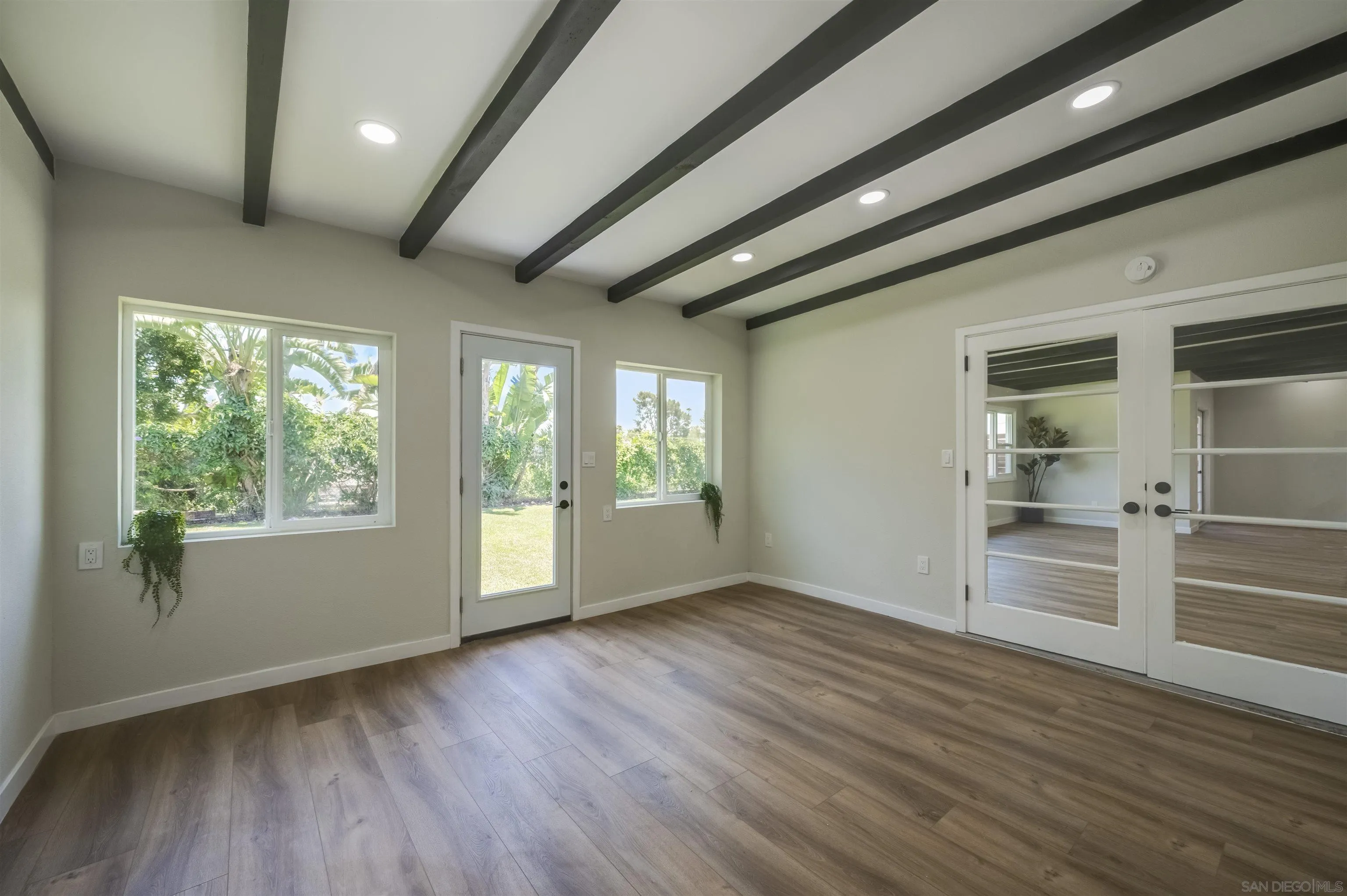 4055 Mt Albertine Avenue San Diego, CA 92111 - Photo 15 of 33 an empty room with wooden floor and windows