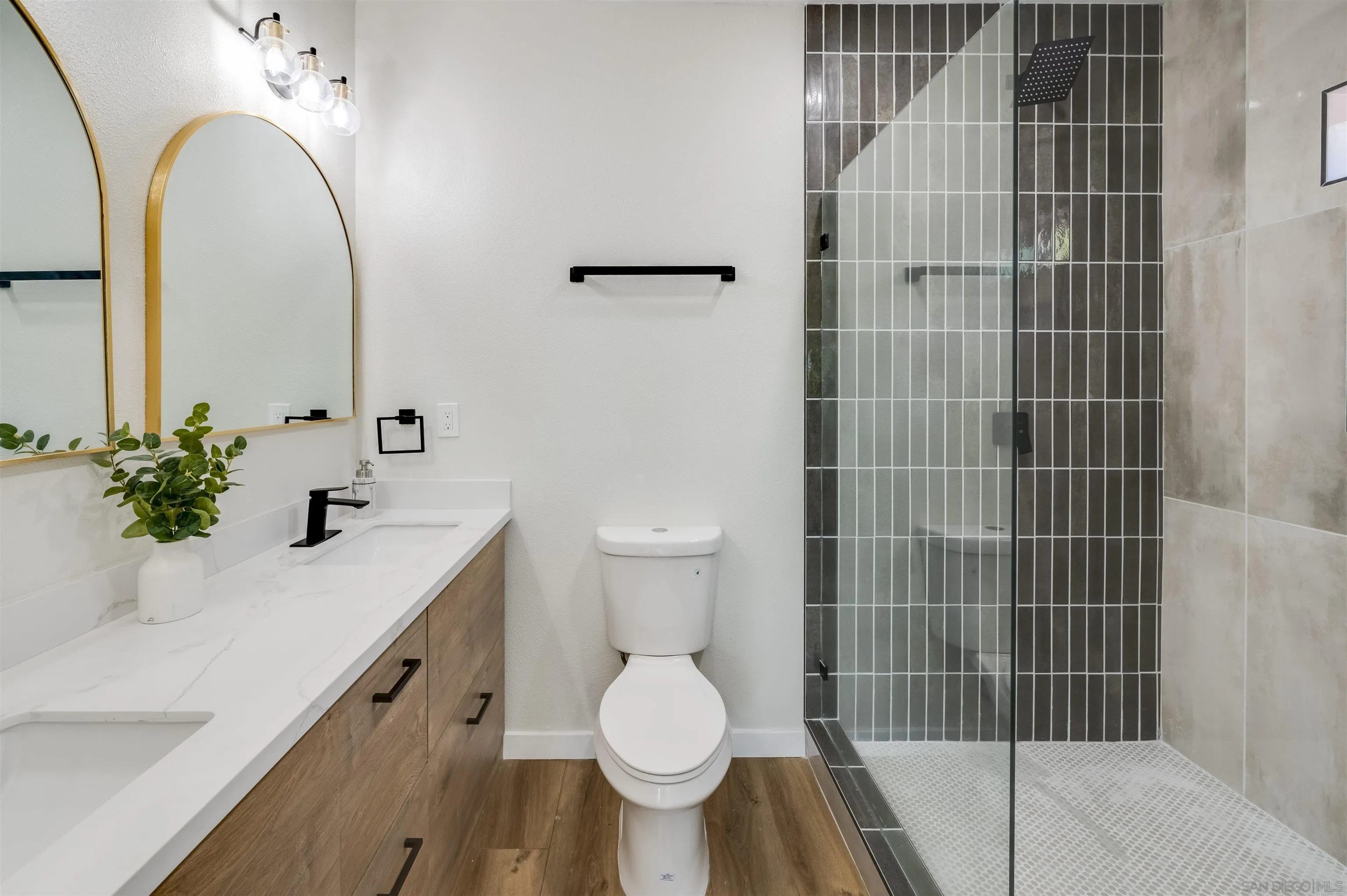 4055 Mt Albertine Avenue San Diego, CA 92111 - Photo 17 of 33 a bathroom with a sink a toilet and shower