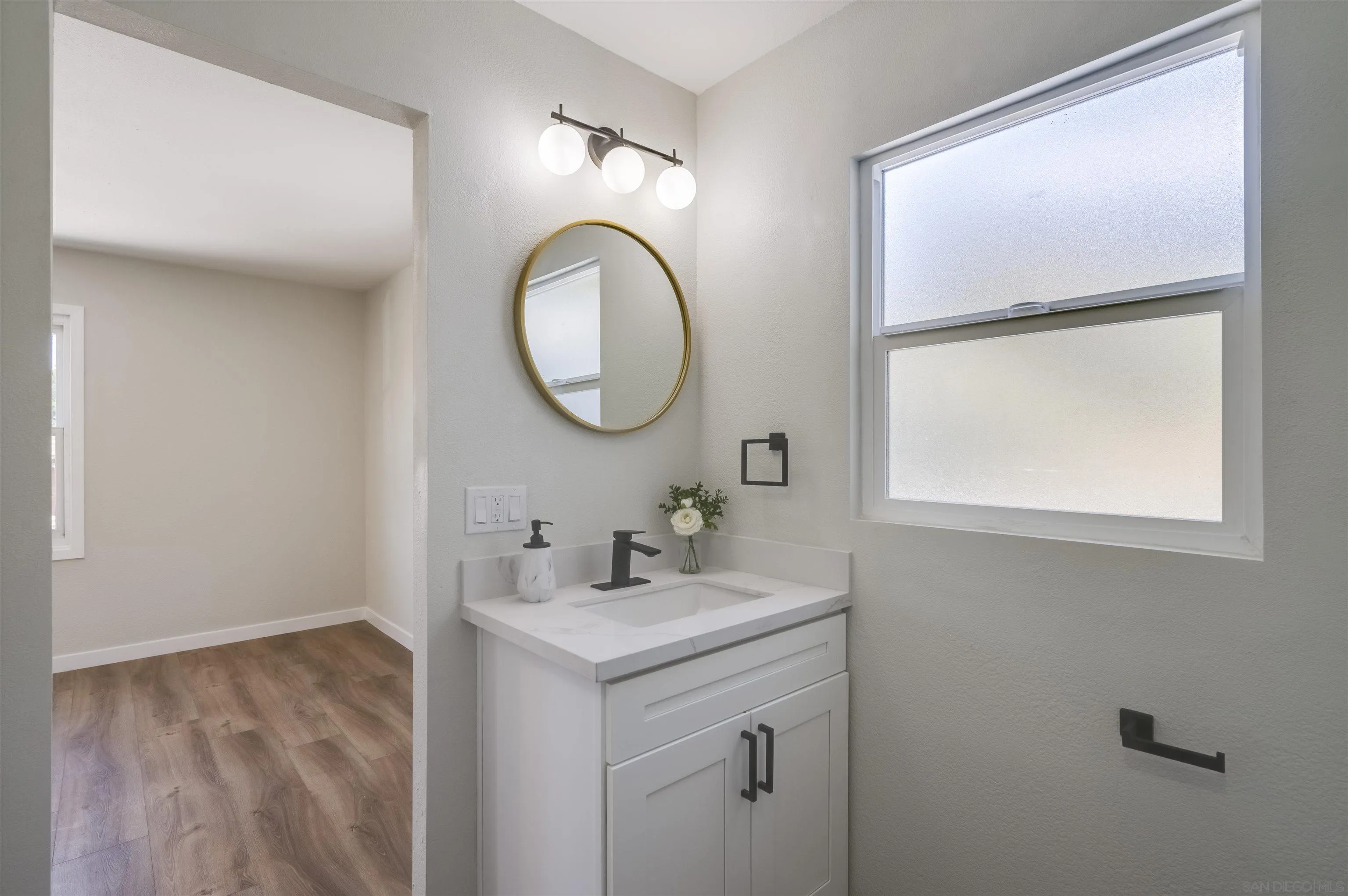 4055 Mt Albertine Avenue San Diego, CA 92111 - Photo 20 of 33 a bathroom with a sink and a mirror