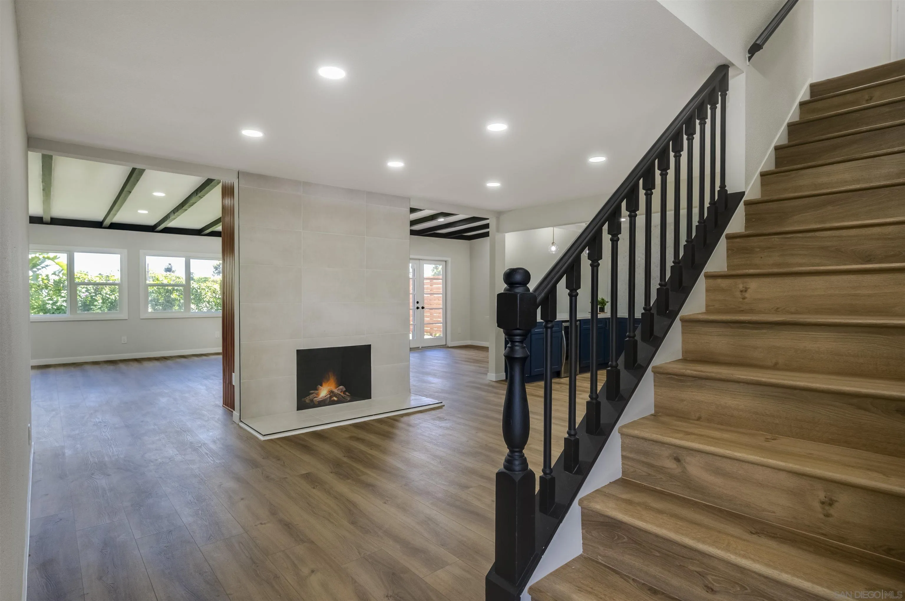 4055 Mt Albertine Avenue San Diego, CA 92111 - Photo 2 of 33 a view of staircase with fireplace and wooden floor