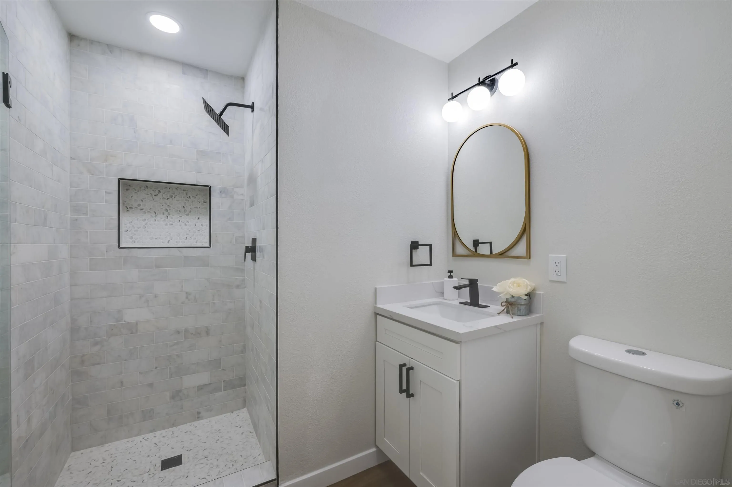 4055 Mt Albertine Avenue San Diego, CA 92111 - Photo 22 of 33 a bathroom with a sink toilet and shower
