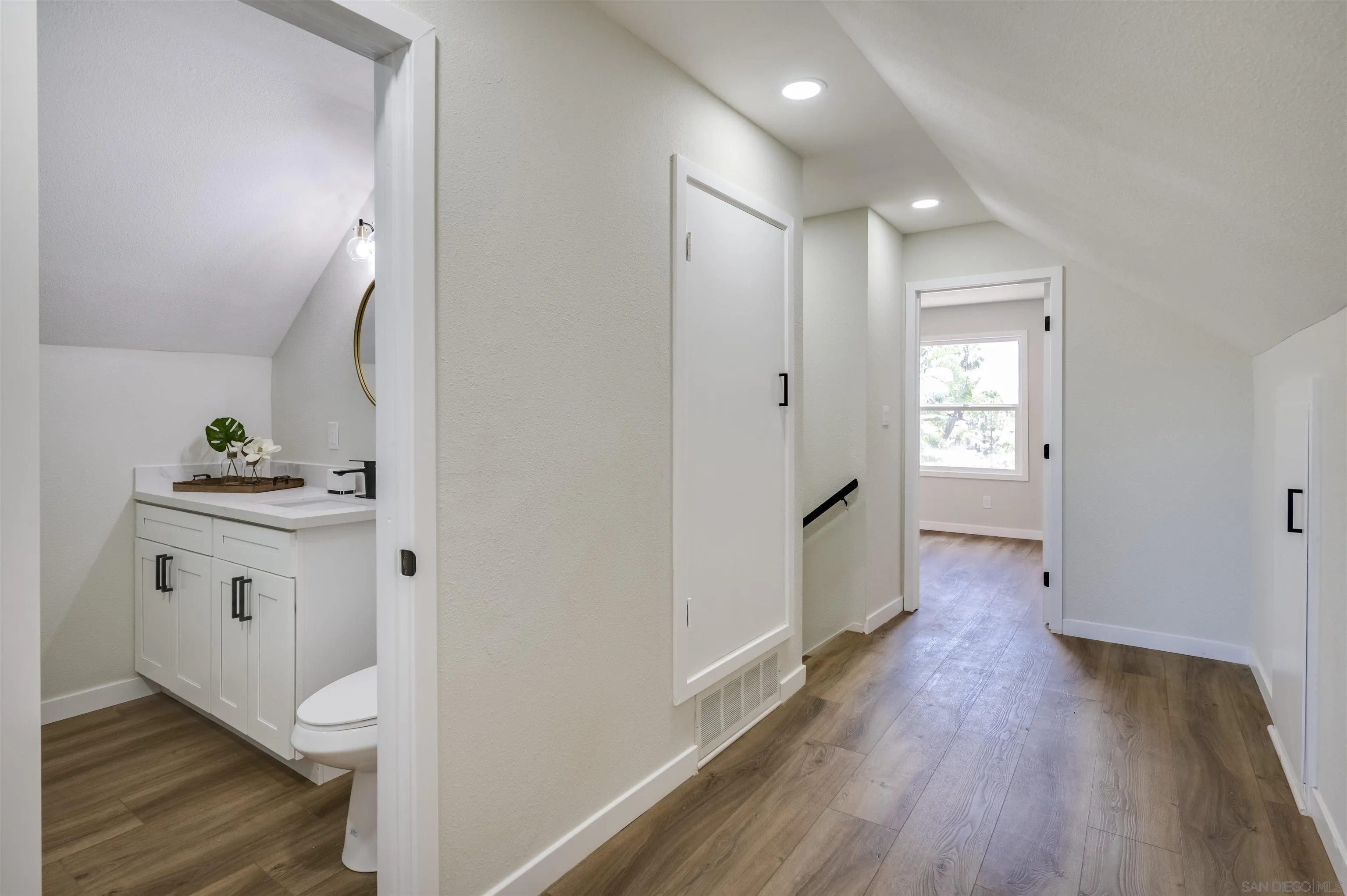 4055 Mt Albertine Avenue San Diego, CA 92111 - Photo 23 of 33 a bathroom with a sink and a mirror