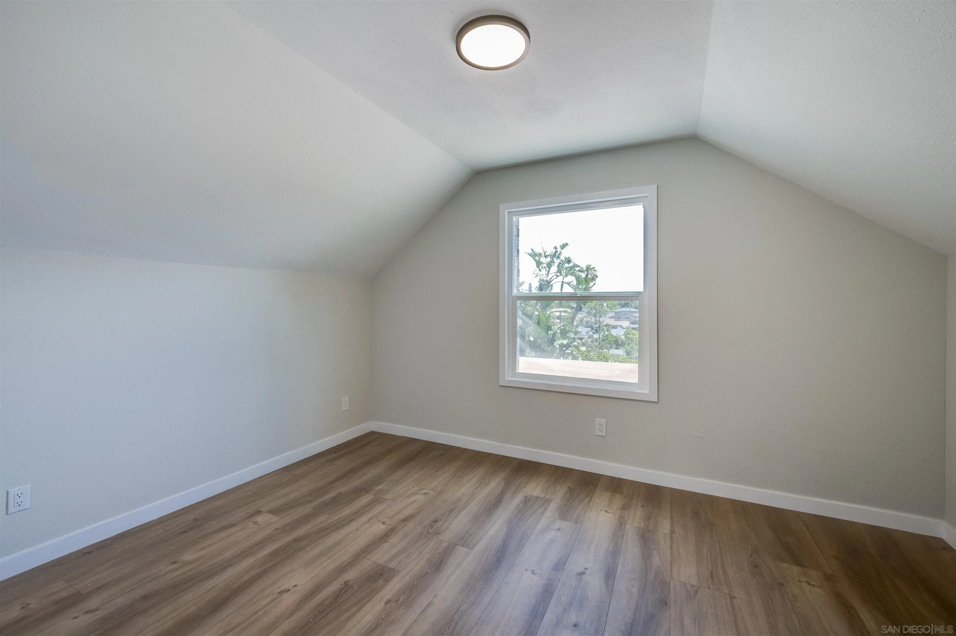 4055 Mt Albertine Avenue San Diego, CA 92111 - Photo 25 of 33 an empty room with wooden floor and windows