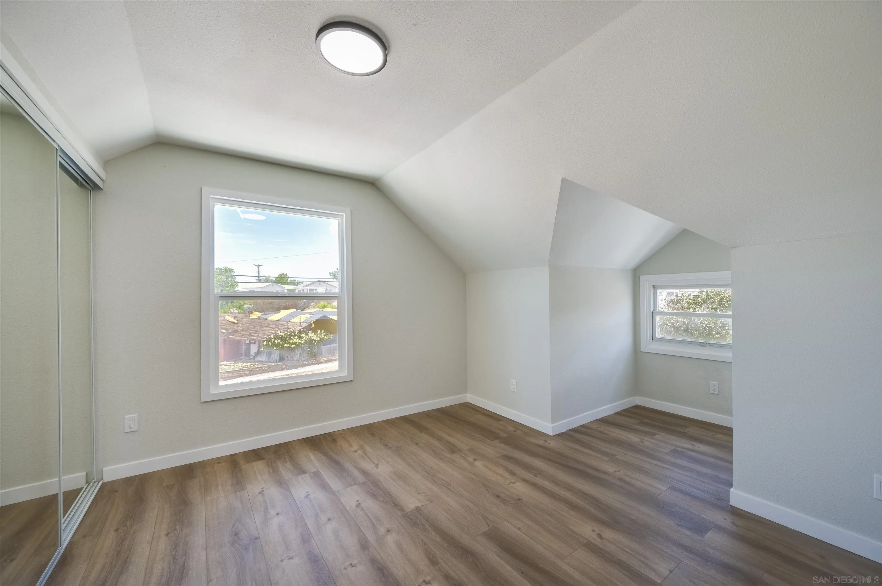 4055 Mt Albertine Avenue San Diego, CA 92111 - Photo 26 of 33 an empty room with wooden floor and windows