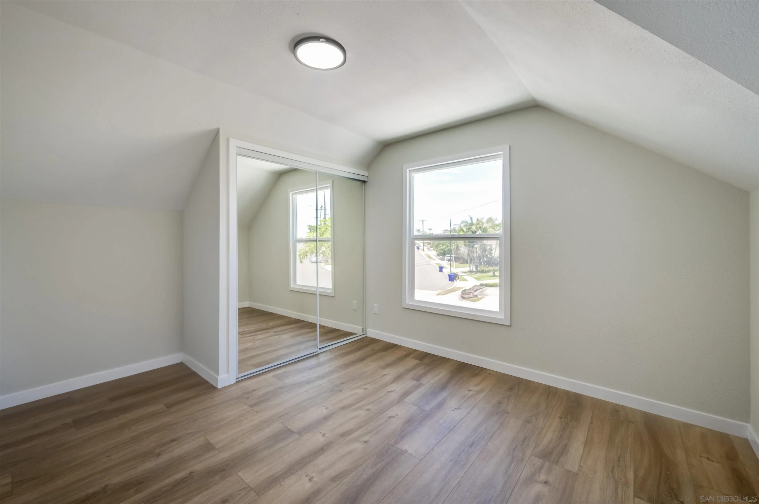 4055 Mt Albertine Avenue San Diego, CA 92111 - Photo 27 of 33 an empty room with wooden floor and windows
