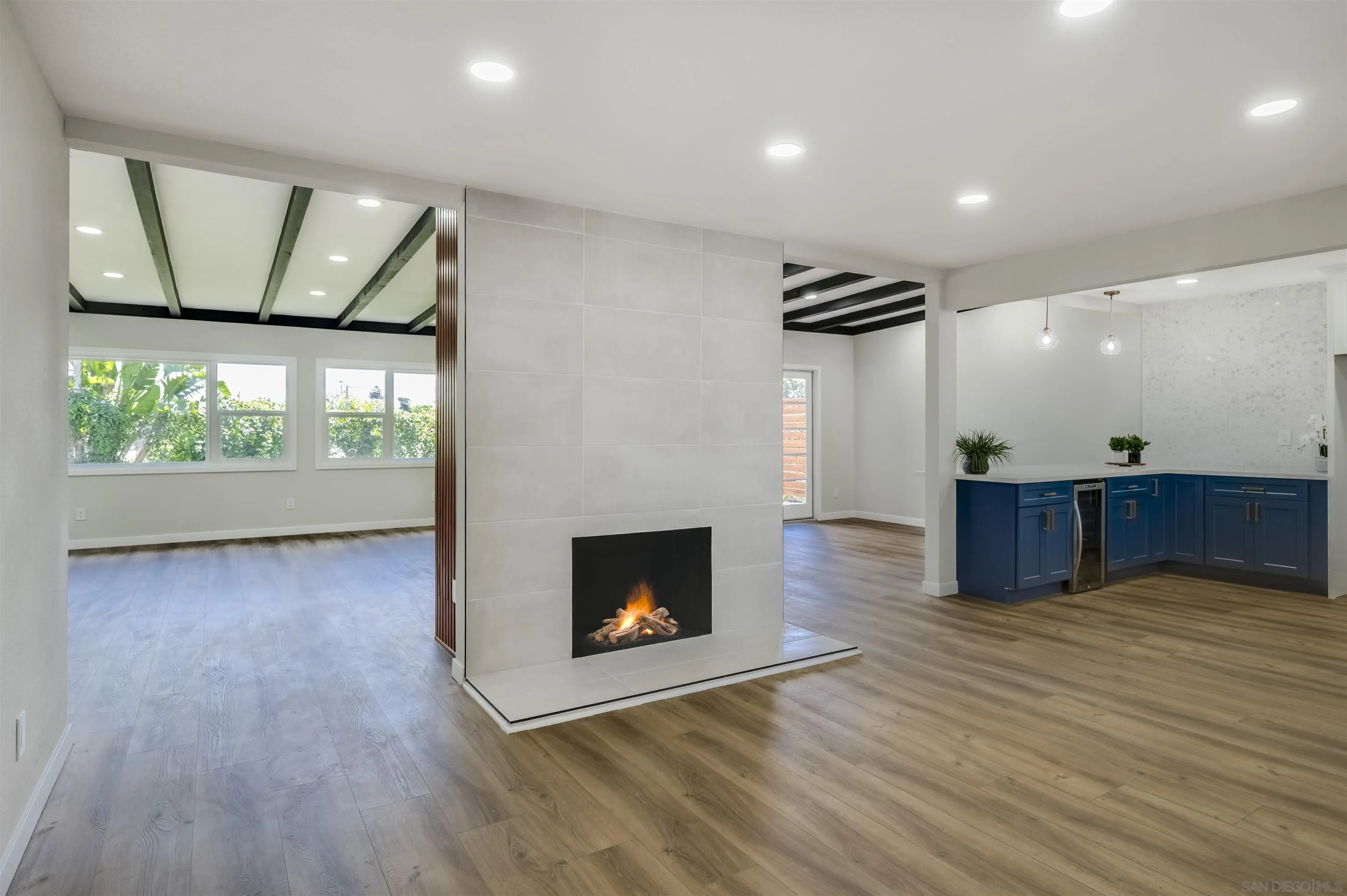 4055 Mt Albertine Avenue San Diego, CA 92111 - Photo 3 of 33 an empty room with wooden floor fire place and windows