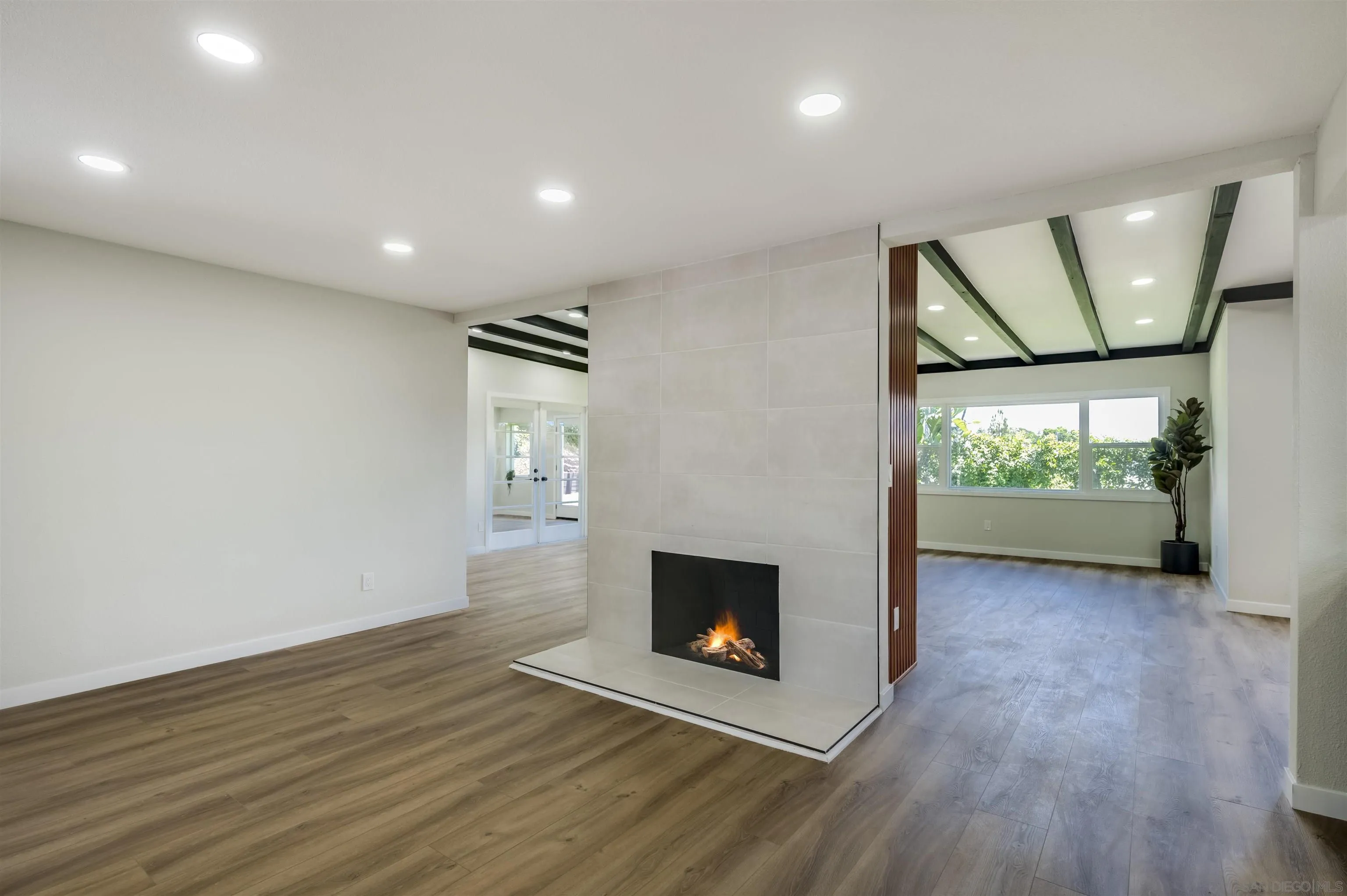 4055 Mt Albertine Avenue San Diego, CA 92111 - Photo 4 of 33 a view of a hallway with wooden floor and a fireplace