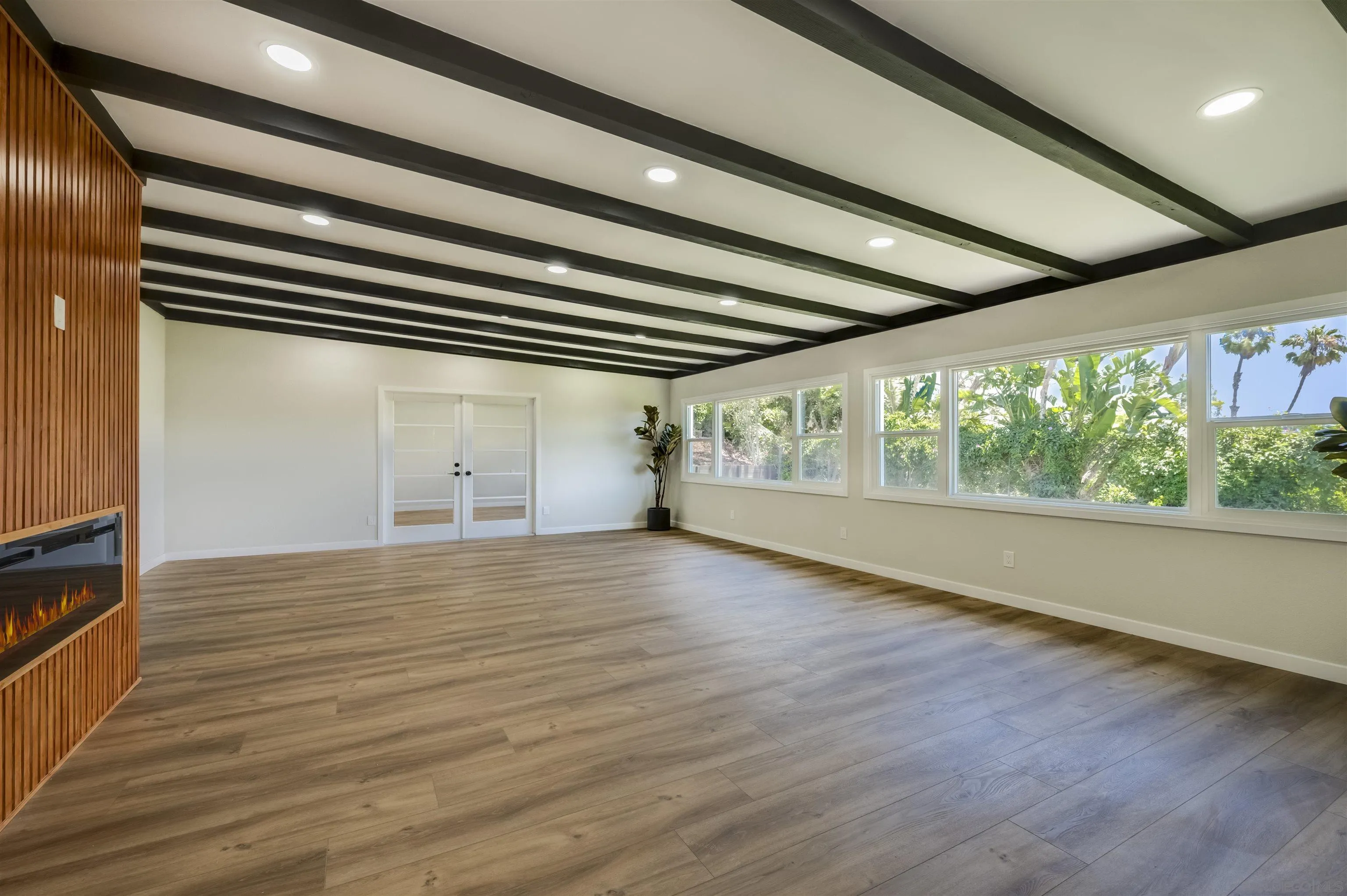 4055 Mt Albertine Avenue San Diego, CA 92111 - Photo 5 of 33 a view of an empty room with wooden floor and a window