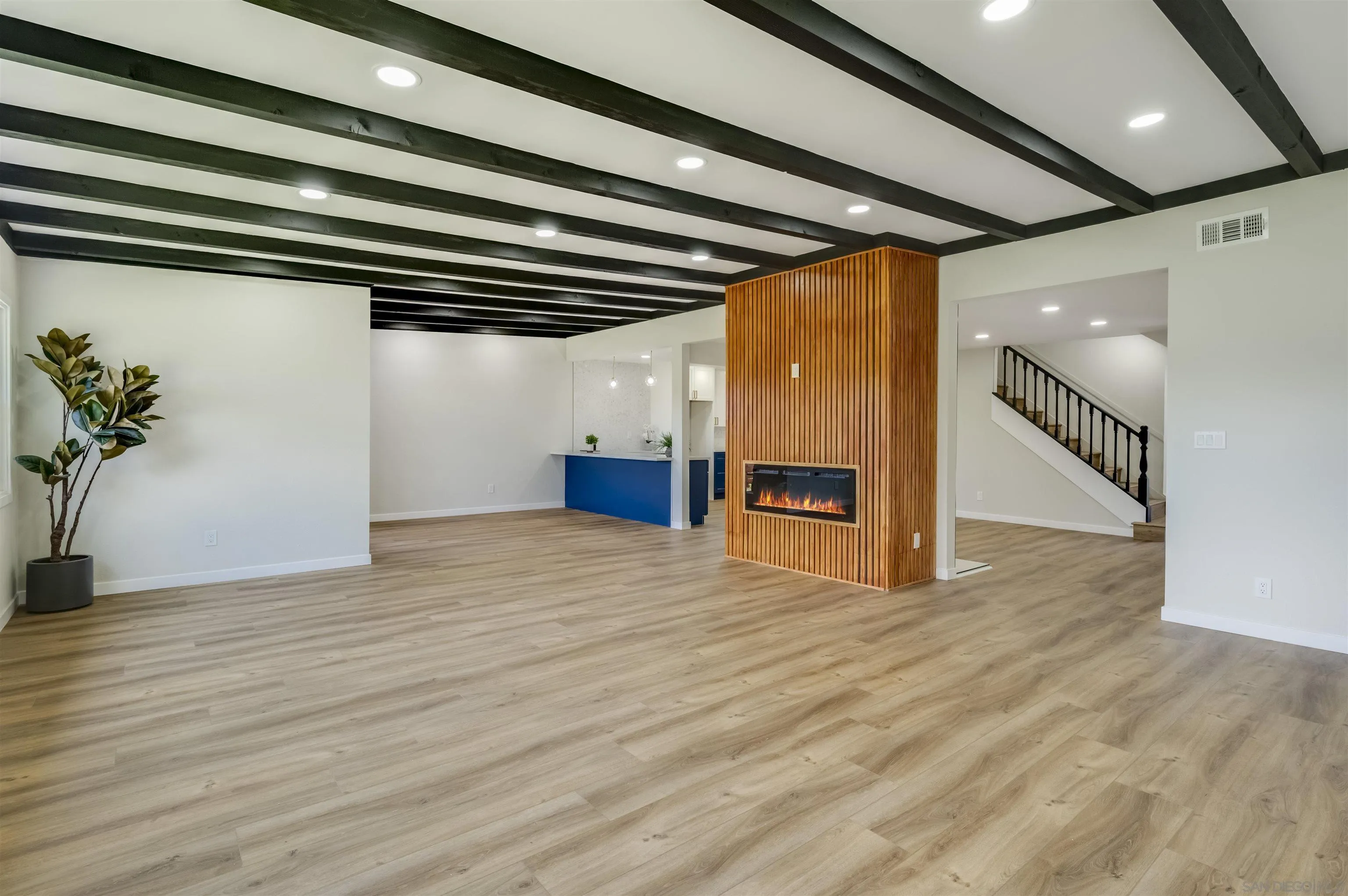 4055 Mt Albertine Avenue San Diego, CA 92111 - Photo 7 of 33 a view of an empty room with wooden floor and stairs