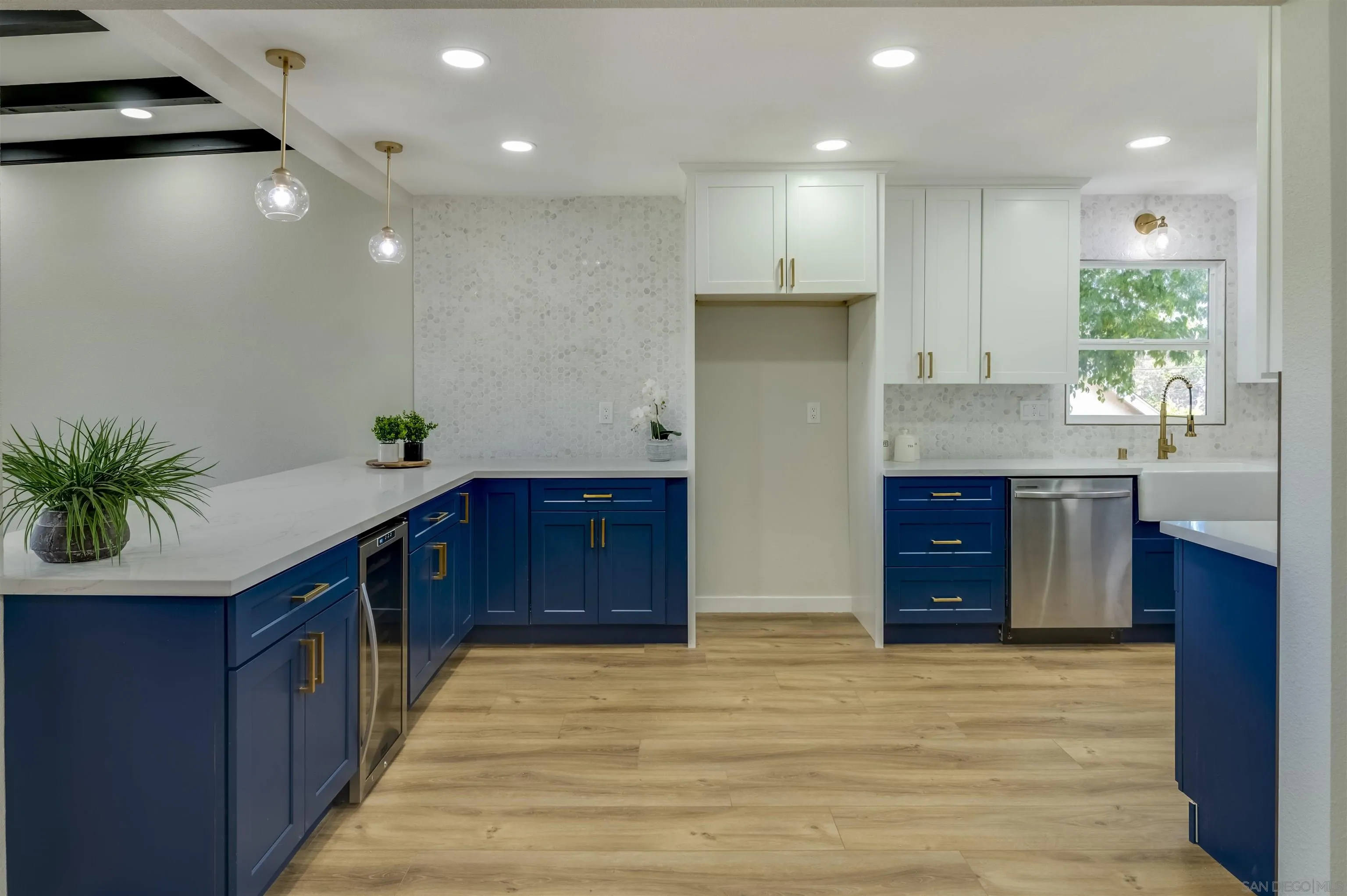 4055 Mt Albertine Avenue San Diego, CA 92111 - Photo 9 of 33 a kitchen with stainless steel appliances granite countertop a large counter top a sink and a refrigerator