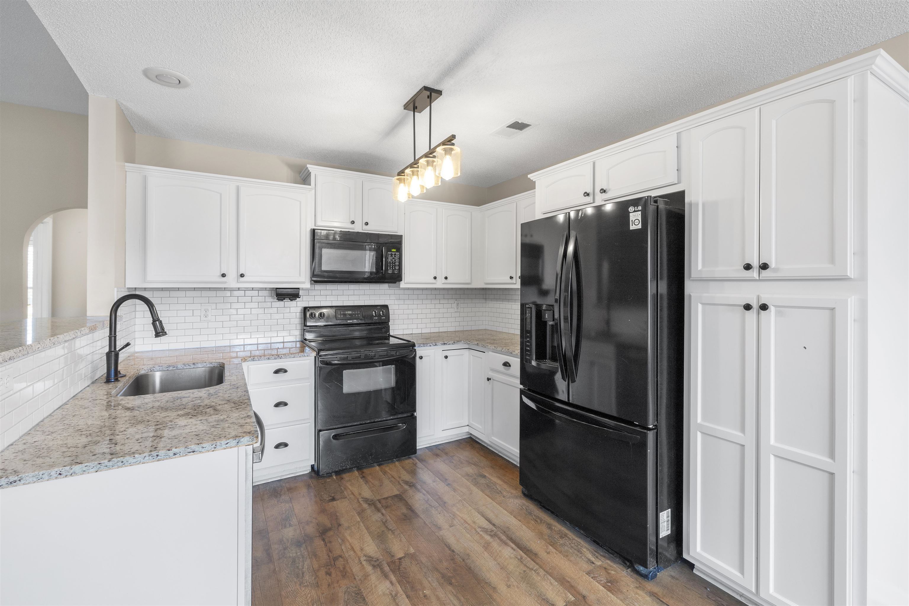 220 Terry Road Somerville, TN 38068 - Photo 11 of 29 a kitchen with granite countertop a refrigerator and a sink