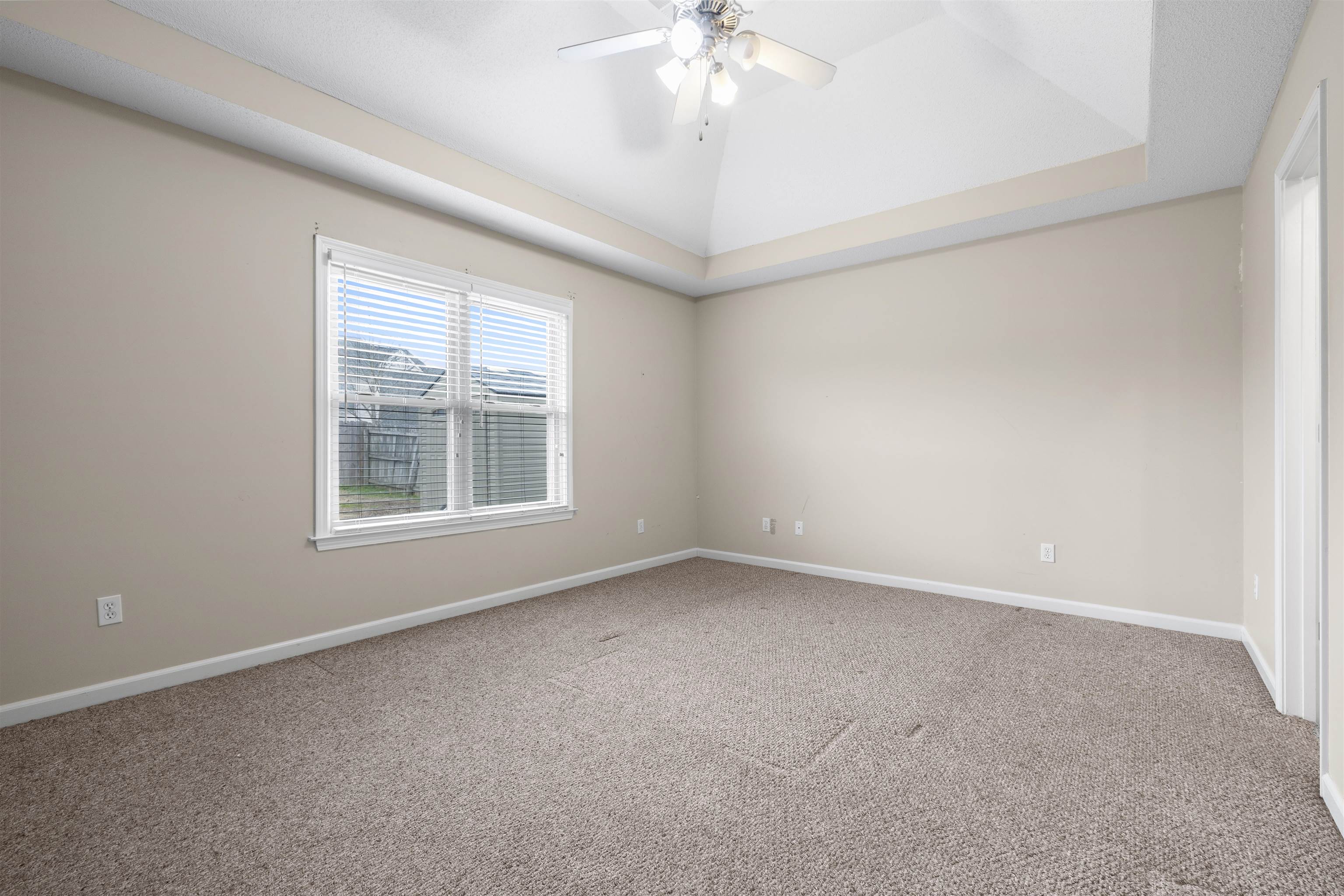 220 Terry Road Somerville, TN 38068 - Photo 15 of 29 an empty room with a chandelier fan and windows