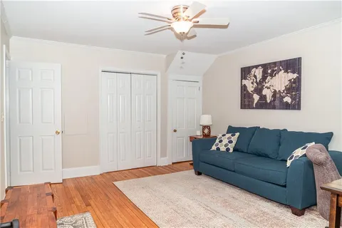 a living room with furniture and a white walls