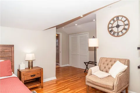 a living room with furniture a lamp and a wooden floor