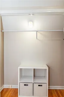 a view of walk in closet with empty racks