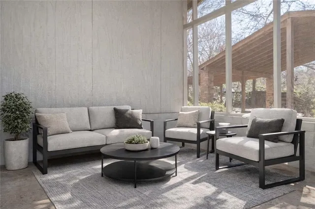 a living room with furniture and a potted plant