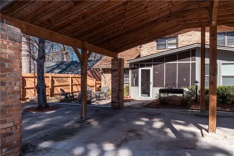 a view of a porch with furniture and floor to ceiling window