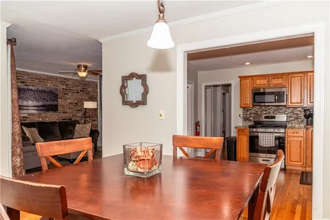a living room with furniture and a kitchen area