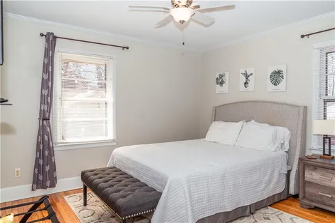 a bedroom with a bed rug and window