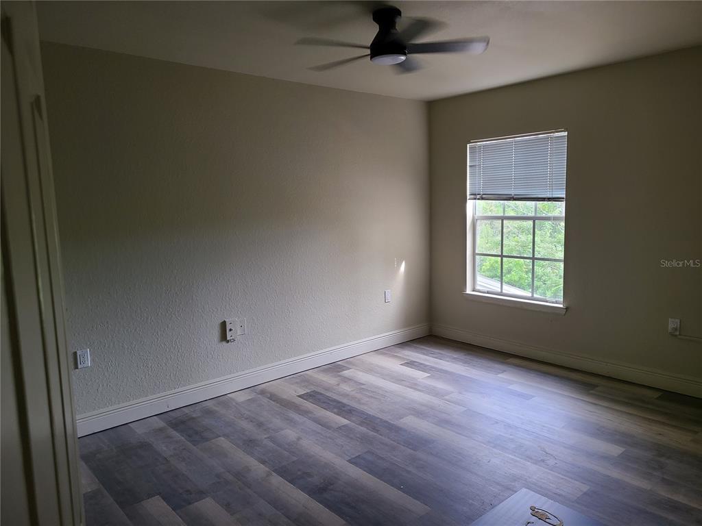 8911 Manor Loop, Unit 205 Lakewood Ranch, FL 34202 - Photo 13 of 33 an empty room with a window and a ceiling fan