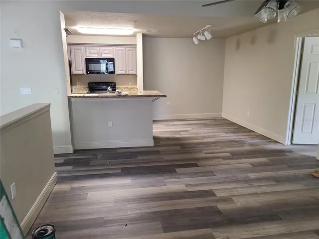 a view of an empty room and wooden floor