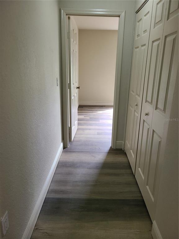 8911 Manor Loop, Unit 205 Lakewood Ranch, FL 34202 - Photo 15 of 33 a view of a hallway with wooden floor and entryway