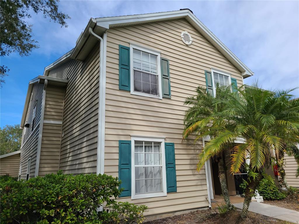 8911 Manor Loop, Unit 205 Lakewood Ranch, FL 34202 - Photo 2 of 33 a front view of a house with a yard