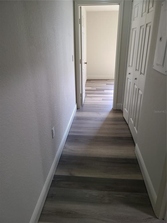 8911 Manor Loop, Unit 205 Lakewood Ranch, FL 34202 - Photo 21 of 33 a view of staircase with wooden floor and white walls