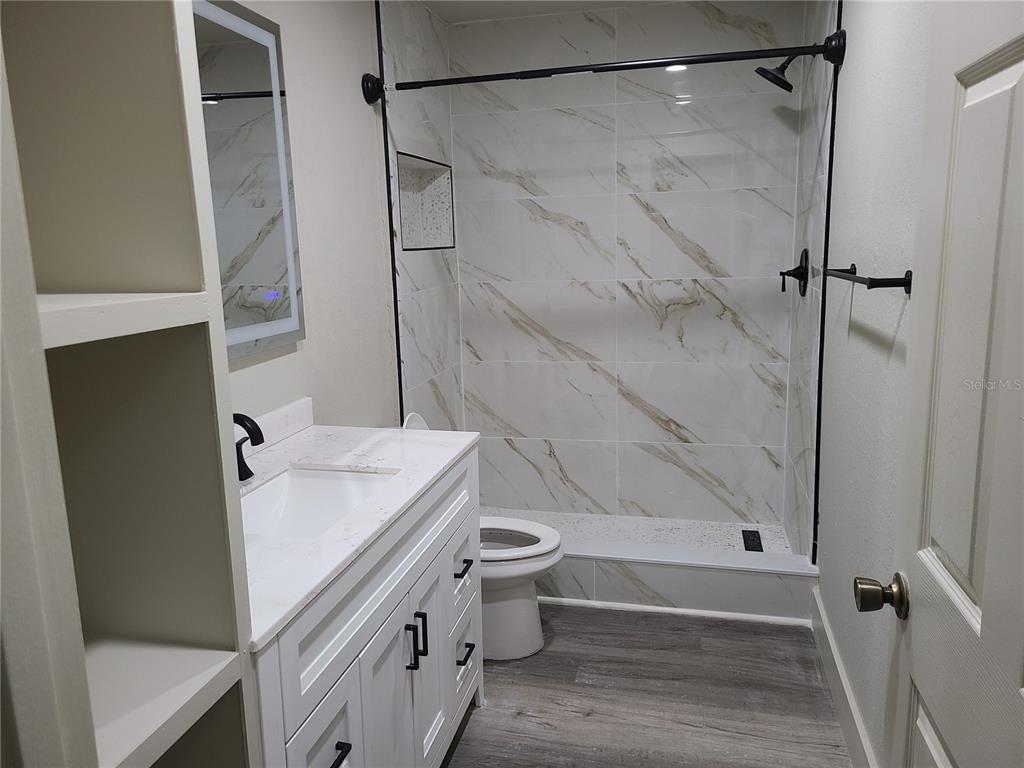 8911 Manor Loop, Unit 205 Lakewood Ranch, FL 34202 - Photo 22 of 33 a bathroom with a sink a toilet and shower