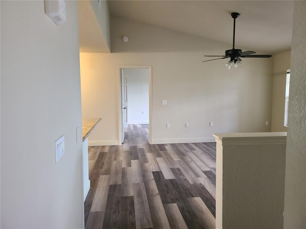8911 Manor Loop, Unit 205 Lakewood Ranch, FL 34202 - Photo 24 of 33 a view of a room with wooden floor and a ceiling fan