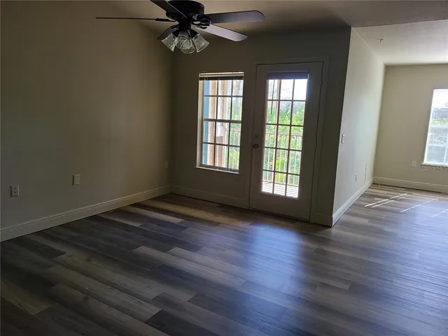a view of staircase with wooden floor and white walls