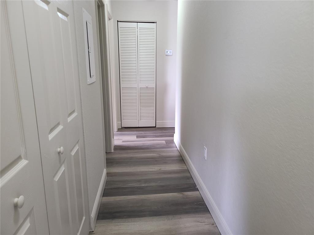 8911 Manor Loop, Unit 205 Lakewood Ranch, FL 34202 - Photo 27 of 33 a view of staircase with white walls and white door