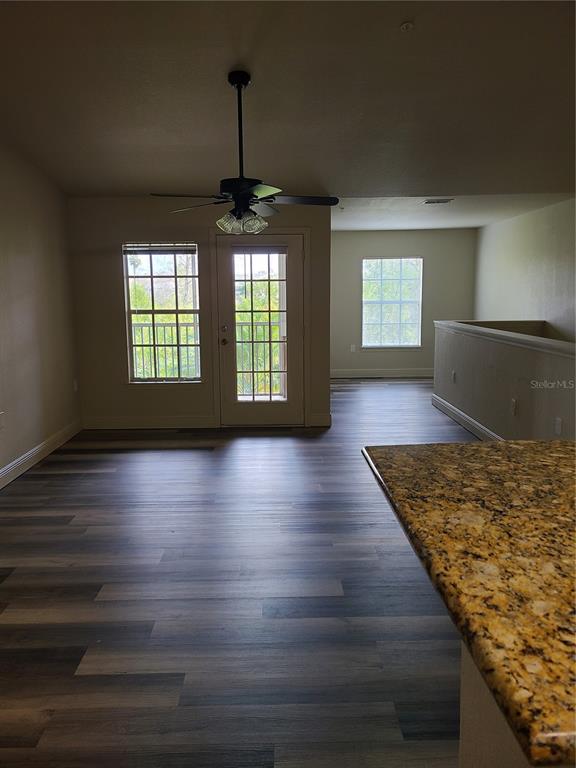 8911 Manor Loop, Unit 205 Lakewood Ranch, FL 34202 - Photo 32 of 33 a view of a livingroom with wooden floor and window