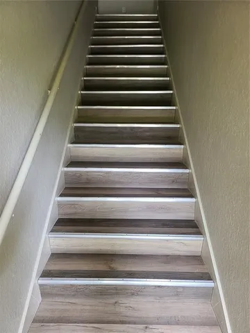 a kitchen with granite countertop a sink stove and refrigerator