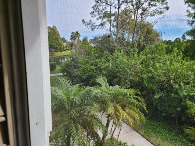 a view of a glass door with a balcony from a window