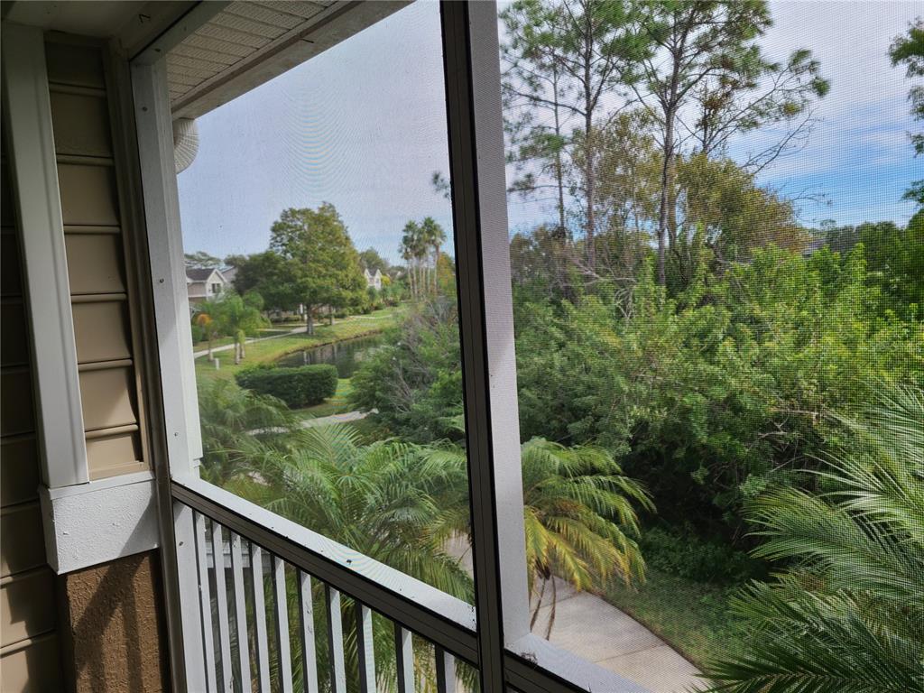 8911 Manor Loop, Unit 205 Lakewood Ranch, FL 34202 - Photo 7 of 33 a view of a glass door with a balcony from a window