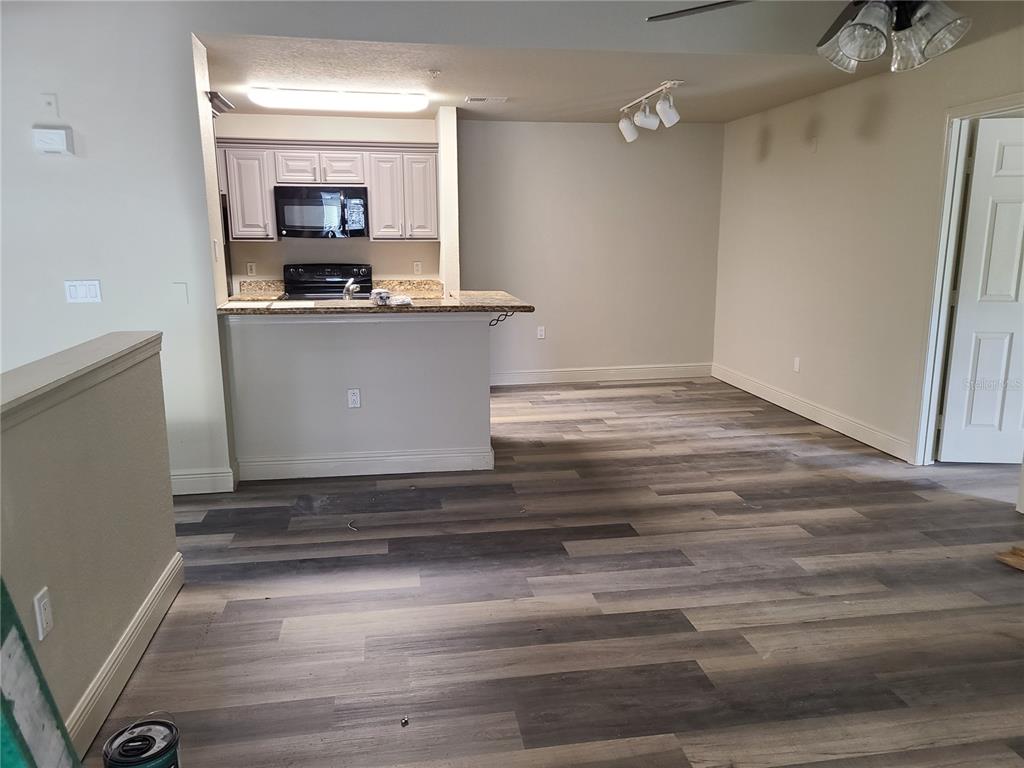 8911 Manor Loop, Unit 205 Lakewood Ranch, FL 34202 - Photo 10 of 33 a view of kitchen cabinets and wooden floor