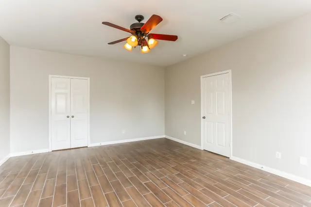 wooden floor in an empty room with a window