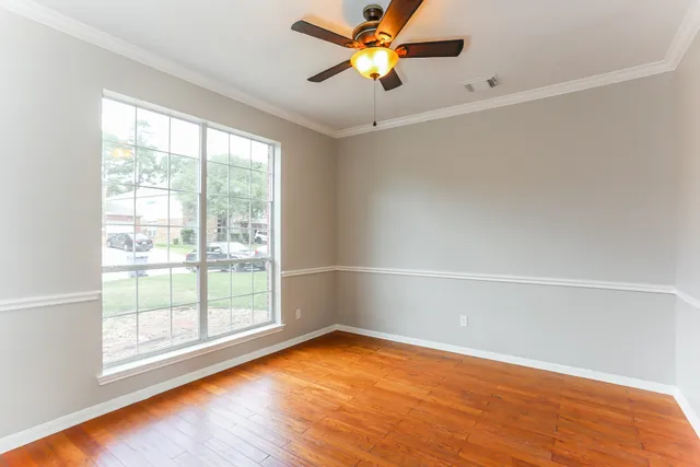 wooden floor in an empty room with a window