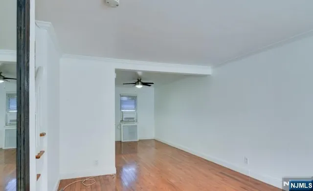 an empty room with wooden floor and closet