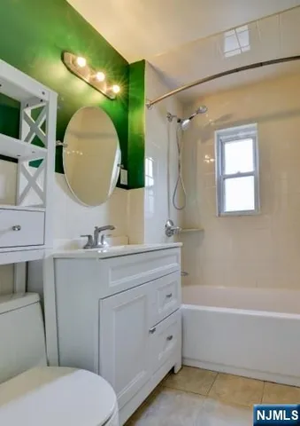 a bathroom with a toilet a sink and a mirror