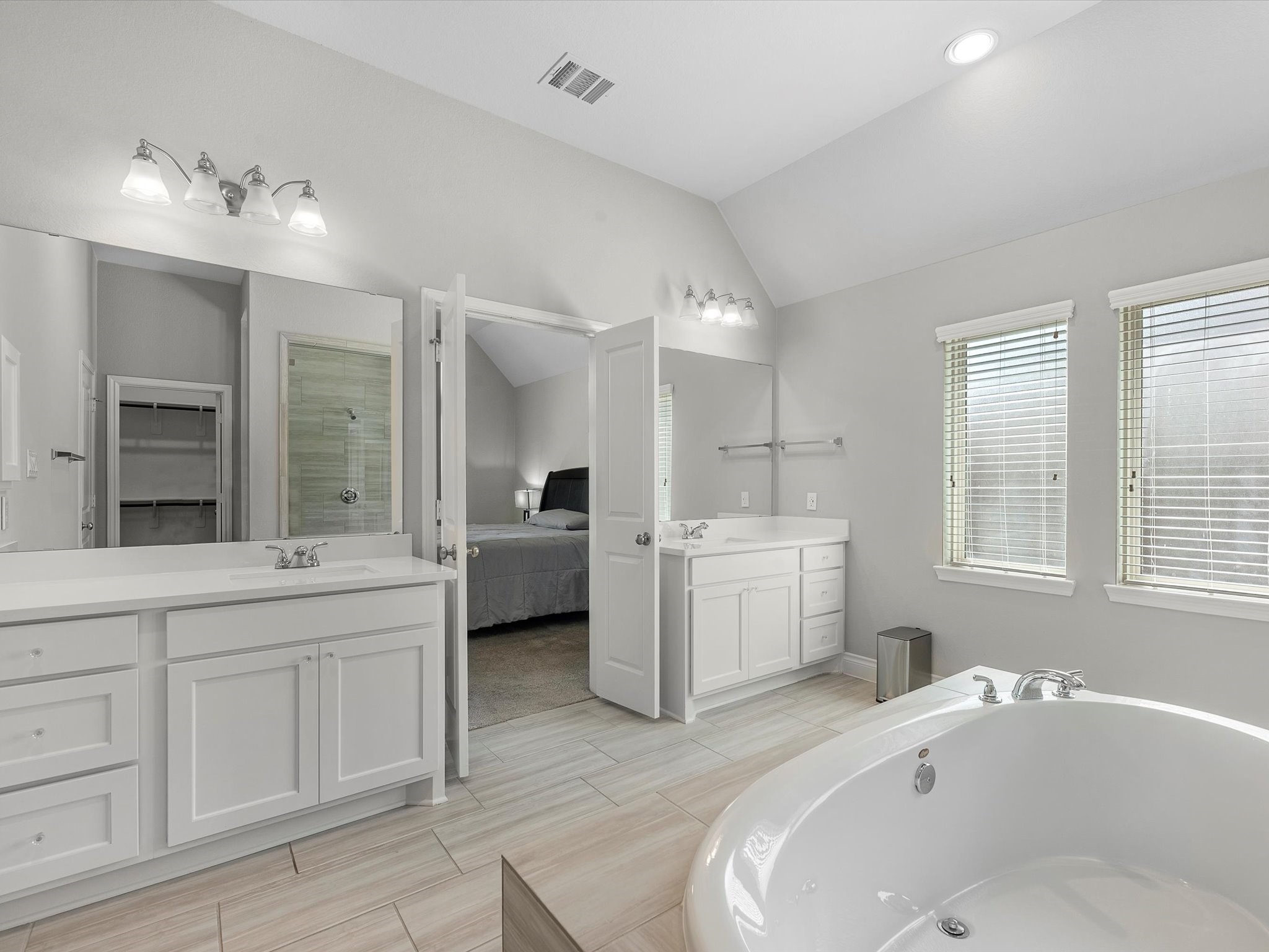 10135 Napier Drive Rosharon, TX 77583 - Photo 12 of 36 Dual vanities with separate sinks, expansive mirrors, and abundant storage complete this luxurious retreat.