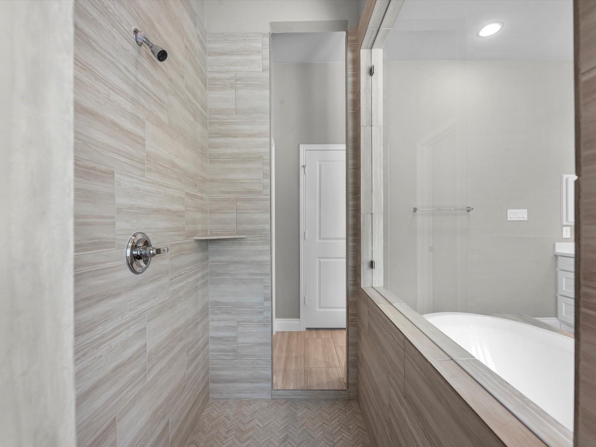 10135 Napier Drive Rosharon, TX 77583 - Photo 13 of 36 The car-wash-style shower is a standout feature, accessible from either side for a sleek, open design and convenient access to the closets just behind.